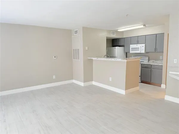 a view of kitchen with refrigerator sink and cabinets