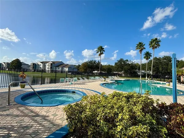 a view of swimming pool with a garden and lake view