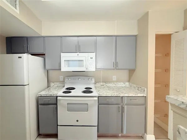 a white refrigerator freezer sitting inside of a kitchen