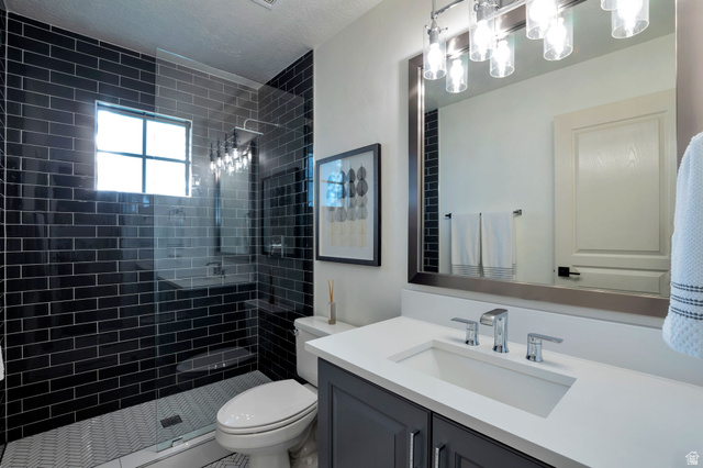 577 South Ridge Top Lane East North Salt Lake, UT 84054 - Photo 19 of 57 Updated secondary bathroom with custom tile, frameless glass shower, and modern finishes.