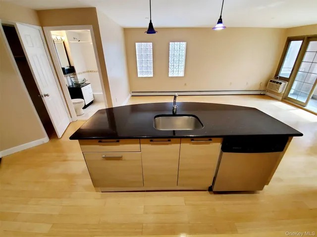 a bathroom with a tub a sink and a mirror