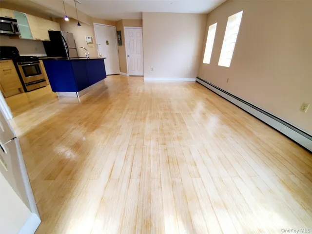 a view of kitchen with cabinets and wooden floor