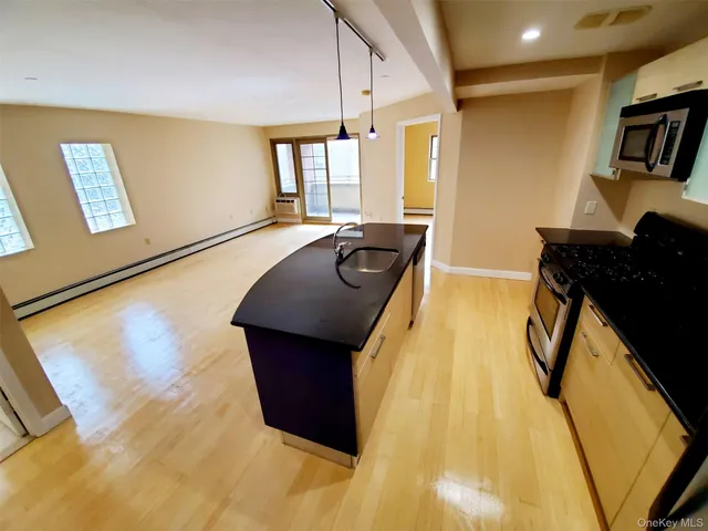 a kitchen with a sink appliances and cabinets