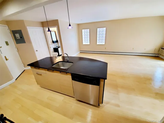 a kitchen with stainless steel appliances granite countertop a sink a stove top oven a counter space and cabinets