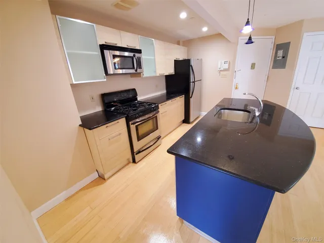 a kitchen with stainless steel appliances granite countertop a granite counter tops and wooden cabinets