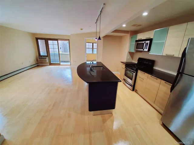 a kitchen with a sink and a mirror