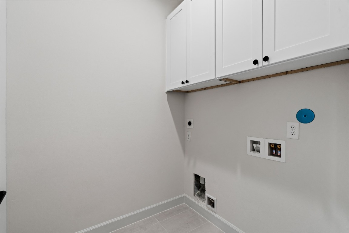 4710 Moving Meadows Houston, TX 77018 - Photo 36 of 42 A generously sized laundry room with built-in cabinets that help keep everything neatly stored.