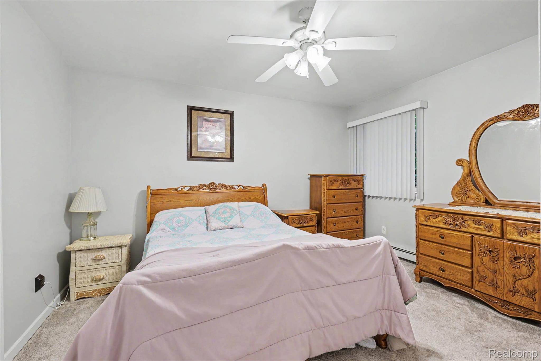 45223 Wear Road Belleville, MI 48111 - Photo 32 of 60 Neutral wall color, ceiling fan, window with vertical blinds, and wall-to-wall carpeting