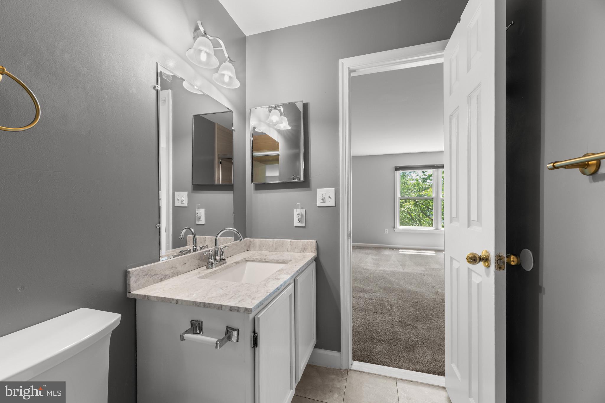 9302 Player Drive, Unit 155 Laurel, MD 20708 - Photo 27 of 43 a bathroom with a sink a toilet and shower