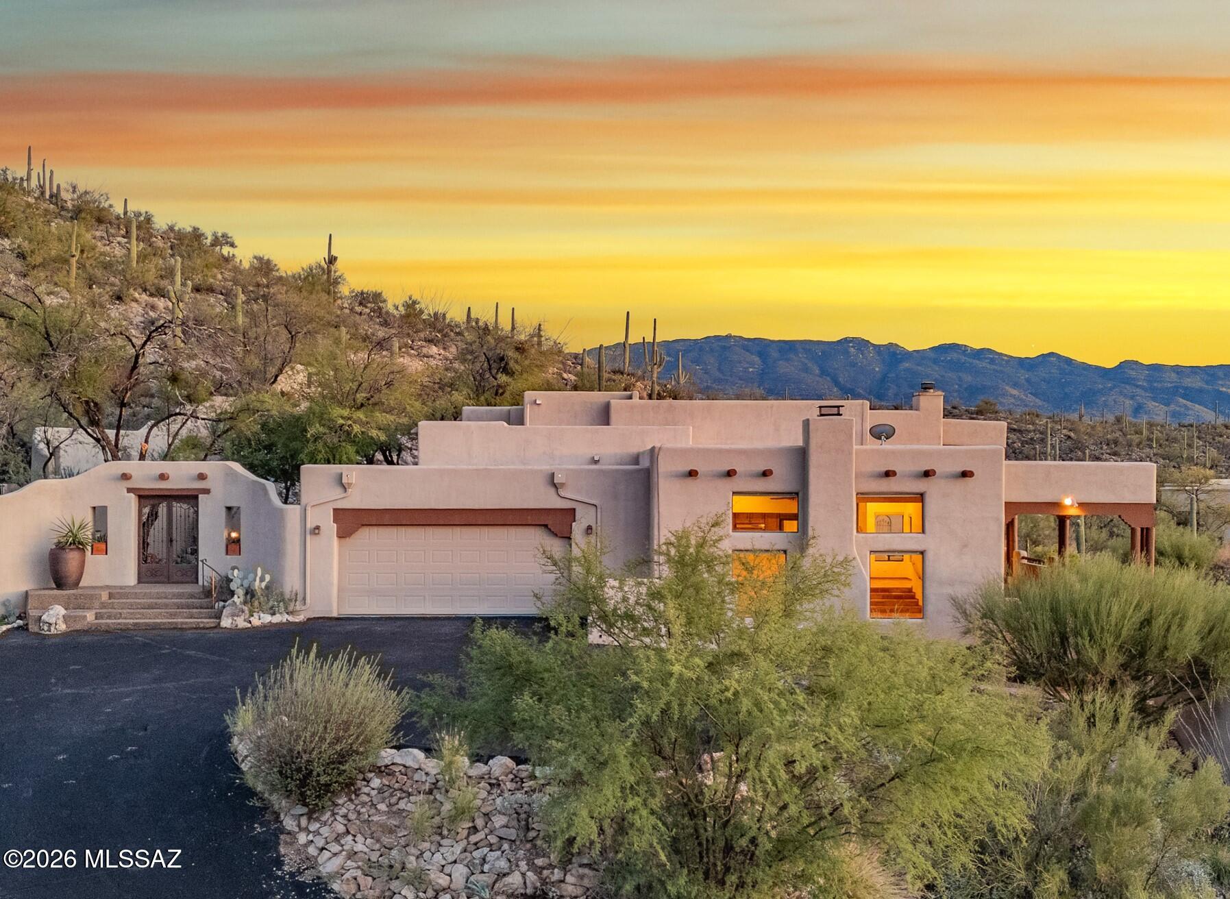 13630 East Sahuaro Sunset Road Tucson, AZ 85749 - Photo 1 of 47 an aerial view of residential houses with outdoor space and trees
