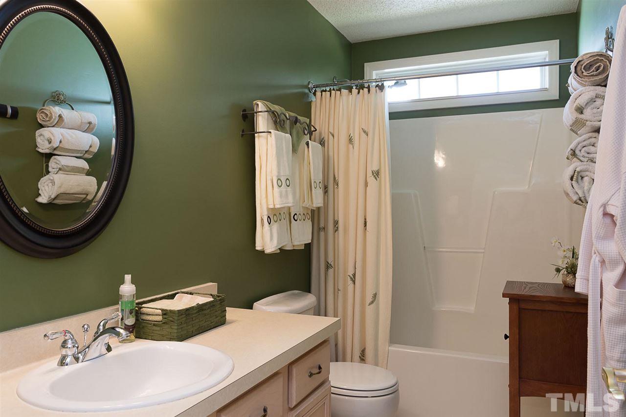 4529 Moss Spring Drive Raleigh, NC 27616 - Photo 11 of 21 a bathroom with a sink toilet and shower