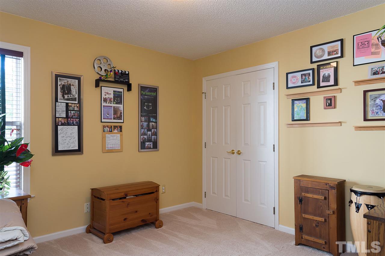 4529 Moss Spring Drive Raleigh, NC 27616 - Photo 12 of 21 a living room with furniture and paintings on the wall