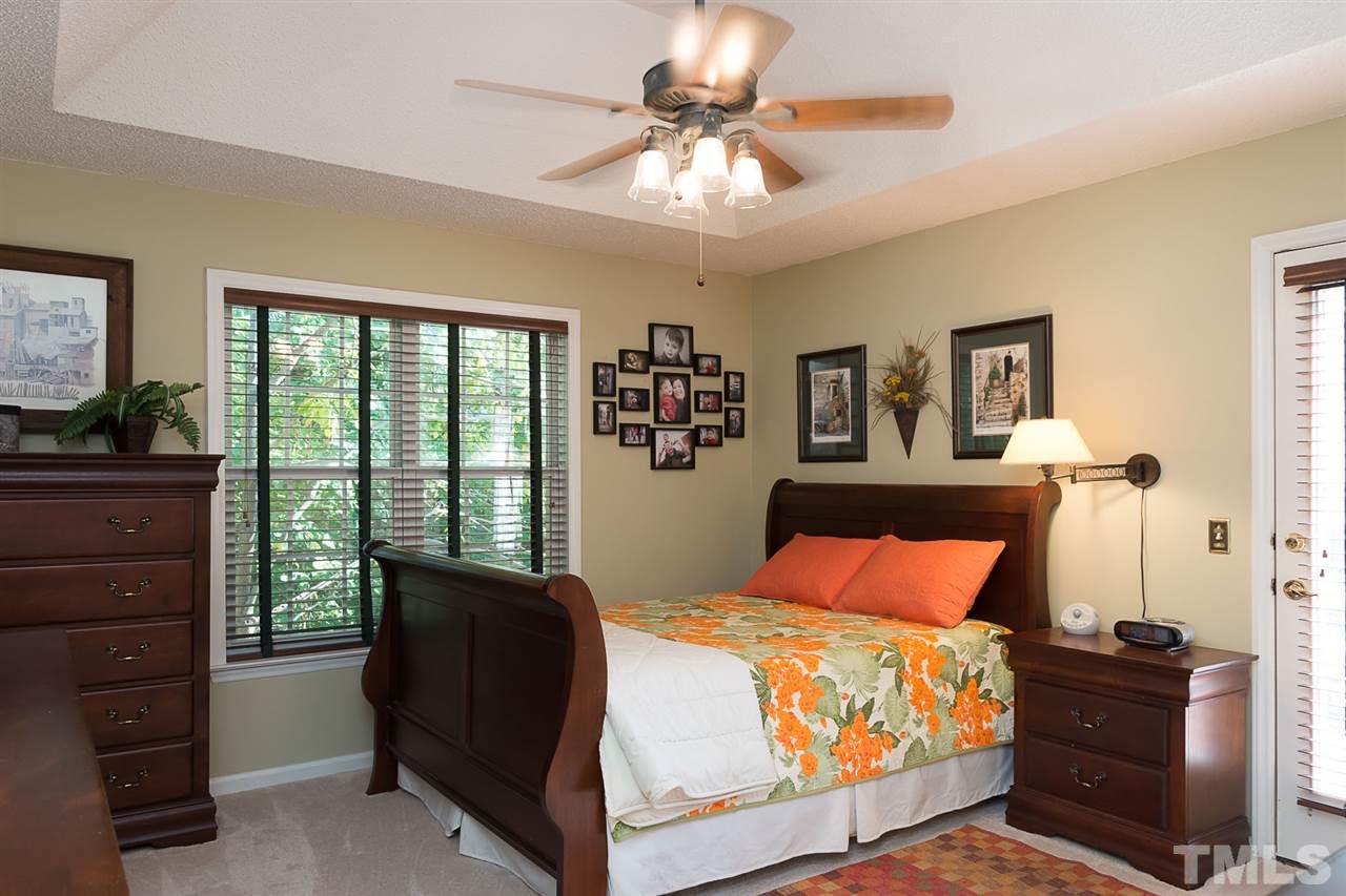 4529 Moss Spring Drive Raleigh, NC 27616 - Photo 13 of 21 a bedroom with a bed and a chandelier