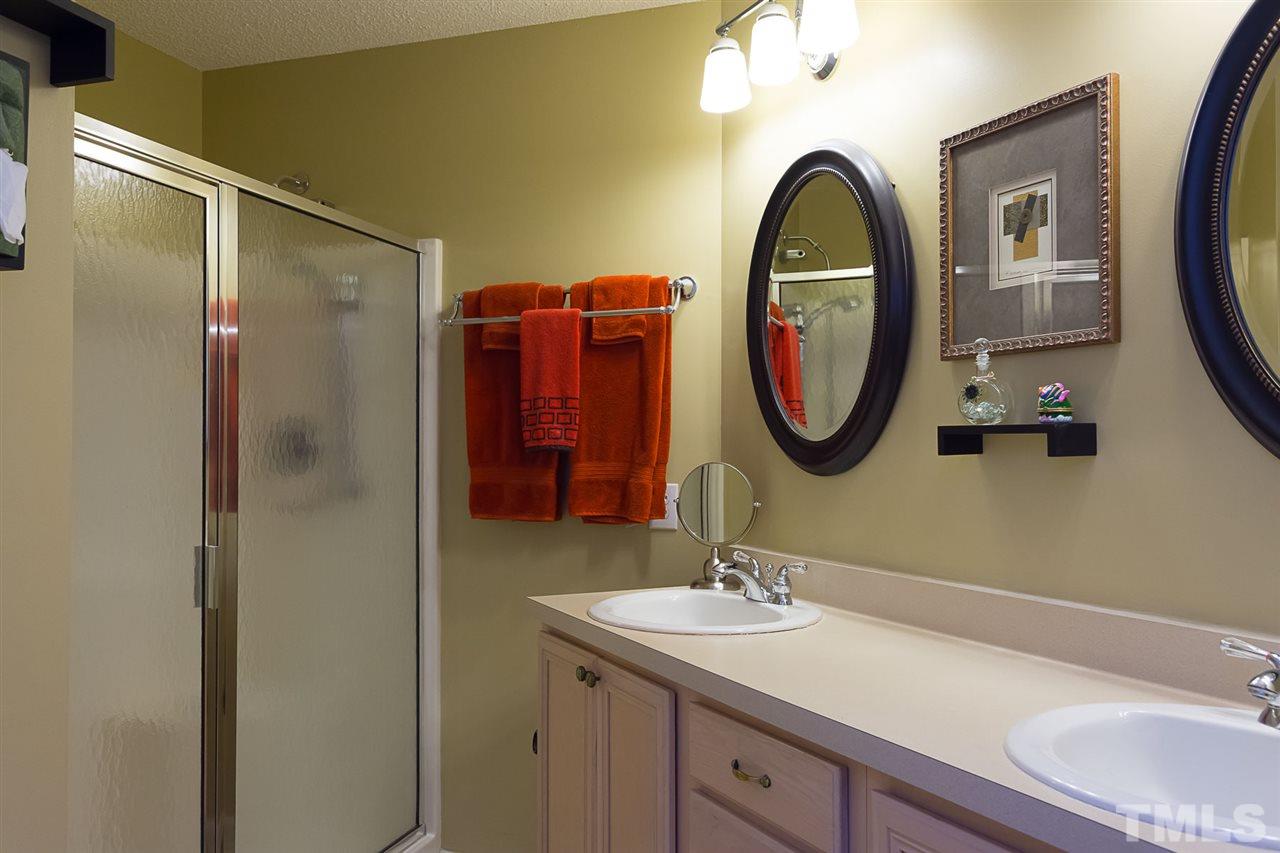 4529 Moss Spring Drive Raleigh, NC 27616 - Photo 15 of 21 a bathroom with a toilet sink and mirror