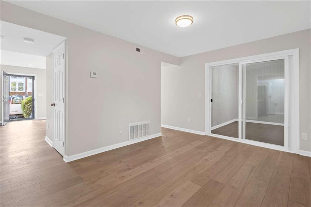 1166 Booth Road, Unit 407 Marietta, GA 30008 - Photo 3 of 18 wooden floor in an empty room with a window