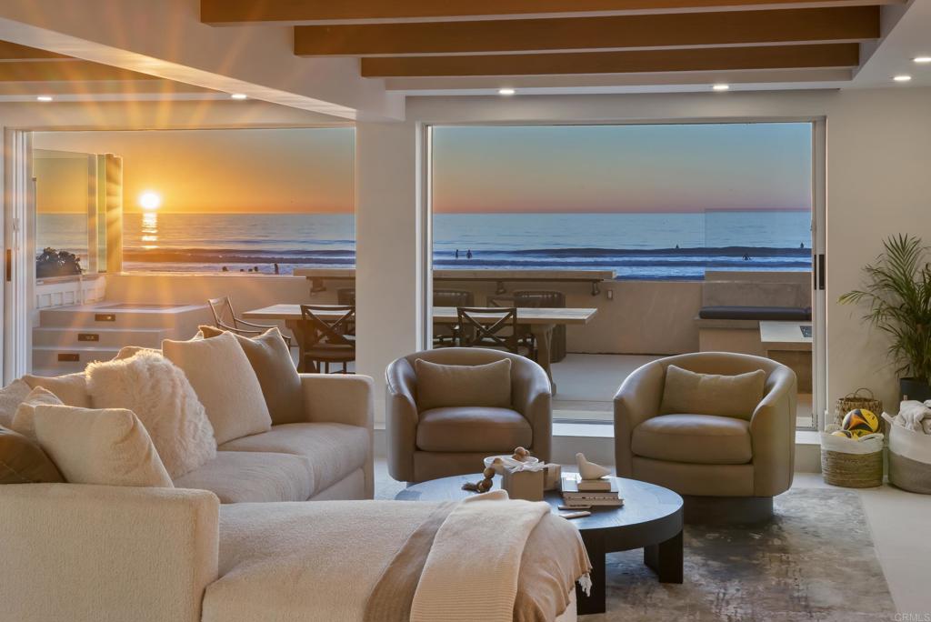 a living room with furniture and a floor to ceiling window