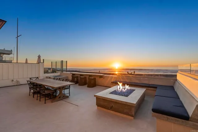 a terrace with outdoor seating and city view