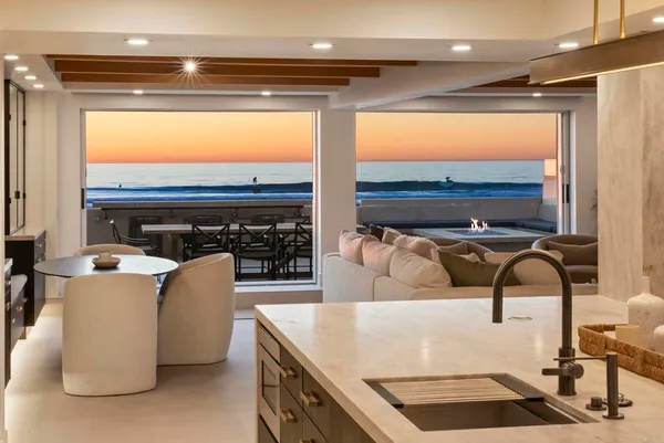 a living room with furniture a flat screen tv and a floor to ceiling window