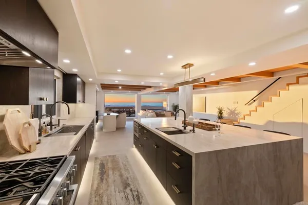 a kitchen with sink stove and cabinets