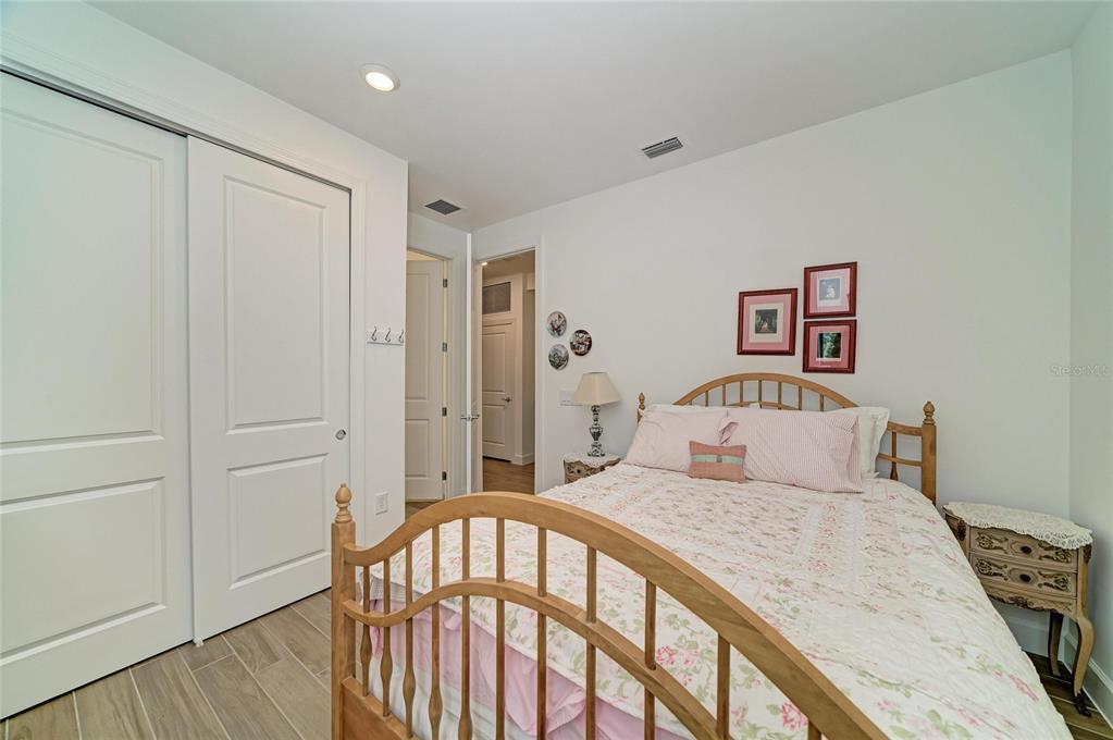 16341 Hidden Oak Loop Lakewood Ranch, FL 34211 - Photo 32 of 76 a bedroom with a bed and a window