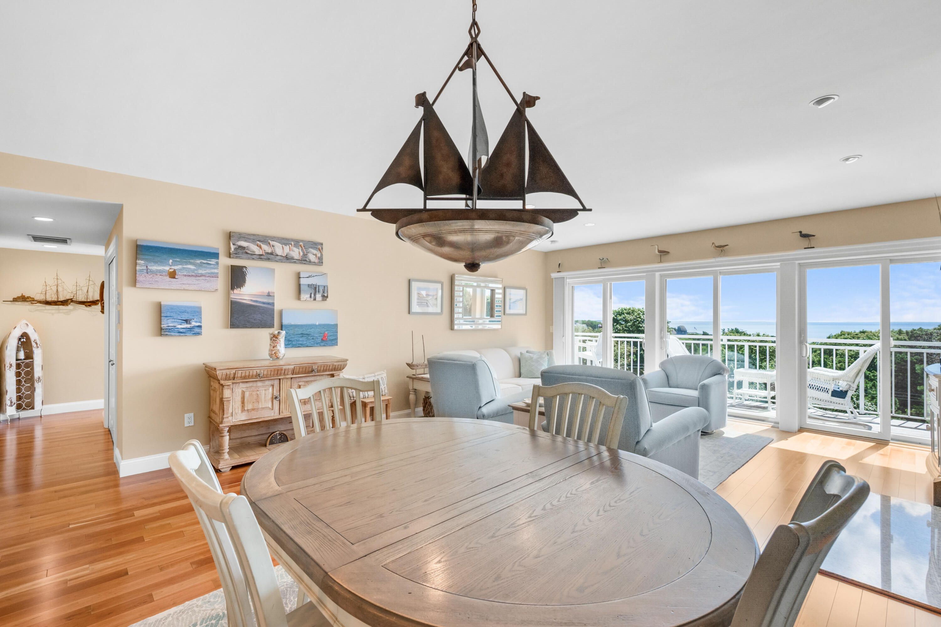 1 Belmont Road, Unit 542 West Harwich, MA 02671 - Photo 15 of 48 a dining room with wooden floor a chandelier a wooden table and chairs