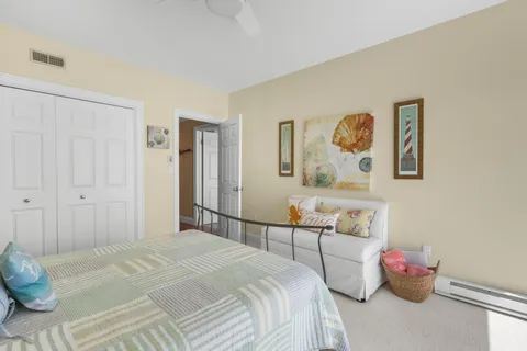 a bedroom with a bed and cabinets