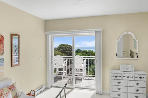 a view of a bedroom with a bed and glass door