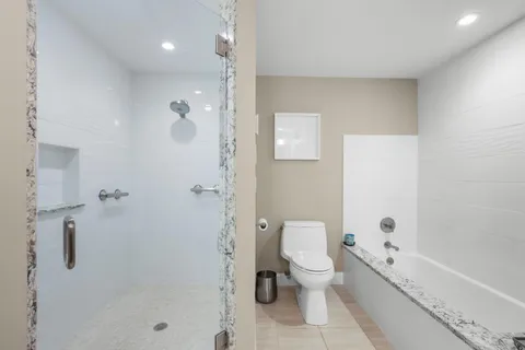 a view of a balcony with wooden floor and outdoor seating