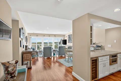 a view of a kitchen with furniture and wooden floor
