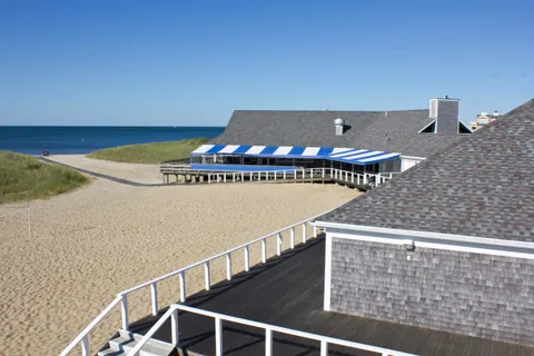 a view of a balcony with mountain view and wooden floor