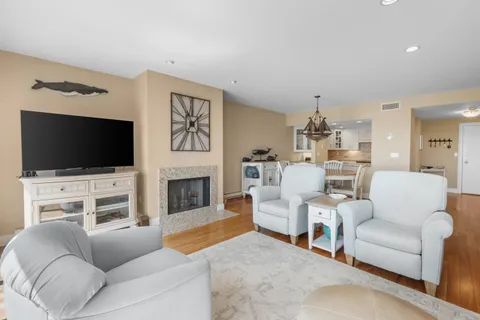 a living room with fireplace furniture and a flat screen tv