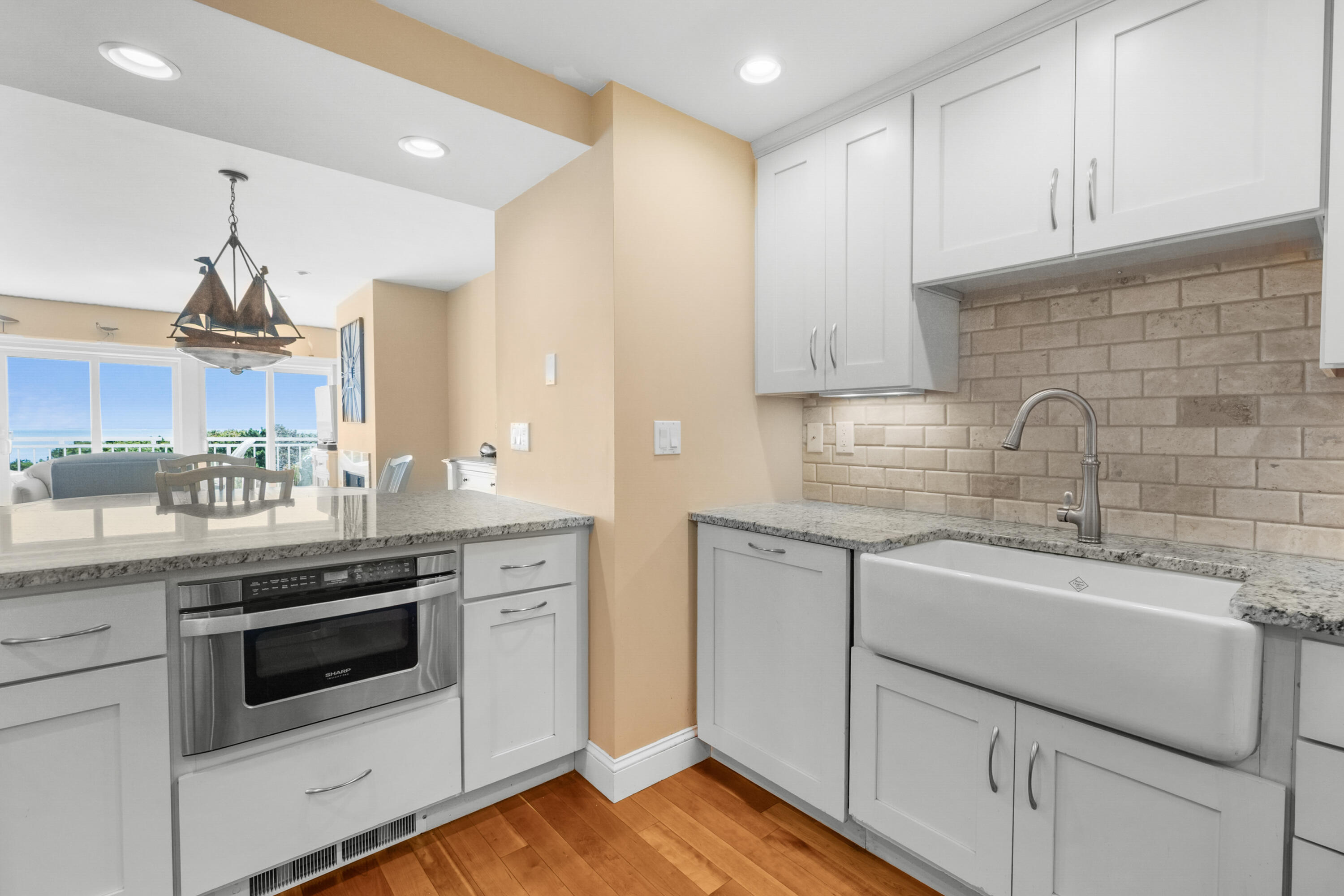 1 Belmont Road, Unit 542 West Harwich, MA 02671 - Photo 10 of 48 a kitchen with white cabinets stainless steel appliances and sink