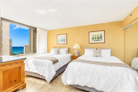 a bedroom with beds and a window