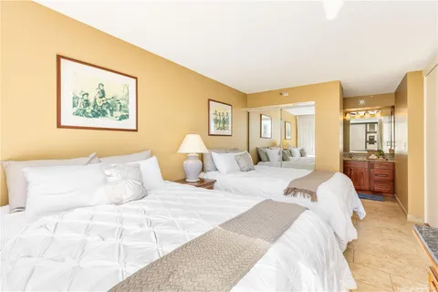 a bedroom with a bed and a painting on the wall