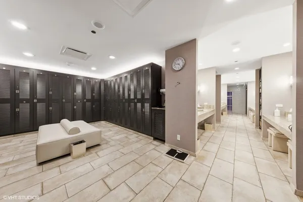 a bathroom with a sink mirror and shower