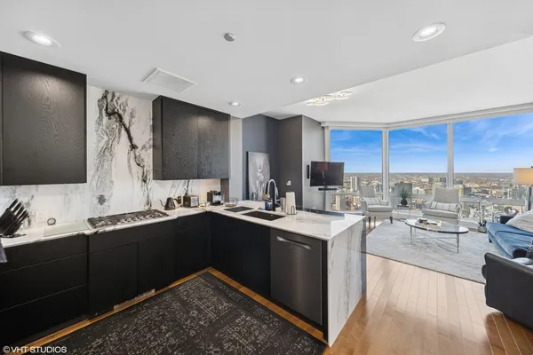 a kitchen with stainless steel appliances granite countertop a sink stove and cabinets