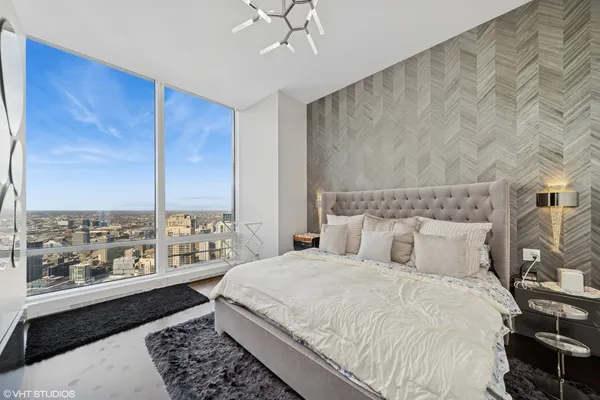 a bedroom with a large bed and a window