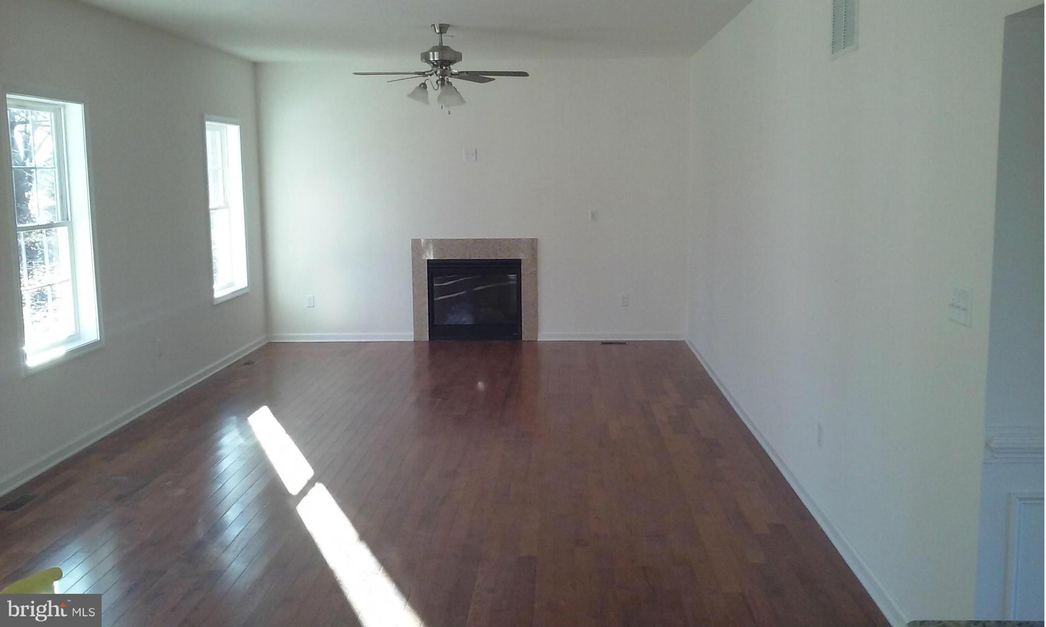 17523 Falls Road Upperco, MD 21155 - Photo 11 of 19 wooden floor in an empty room with a window