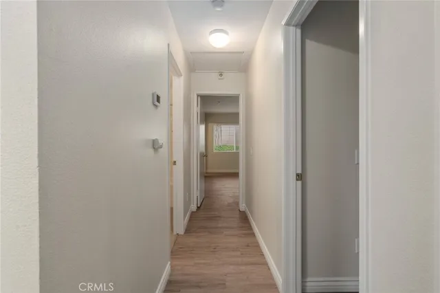a view of a hallway with wooden floor