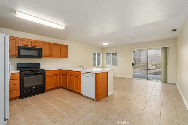 a large kitchen with a stove top oven and cabinets
