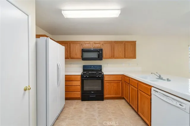 a kitchen with stainless steel appliances granite countertop a stove and a refrigerator