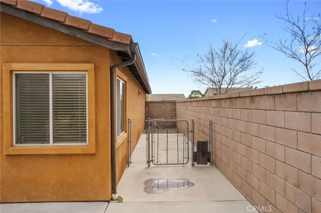 a view of a house with a door and wooden bench