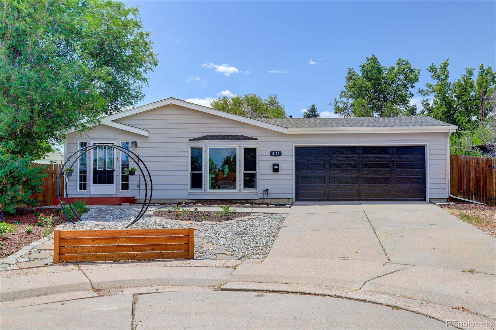 5115 West Custer Place Denver, CO 80219 - Photo 1 of 25 front view of house with a yard