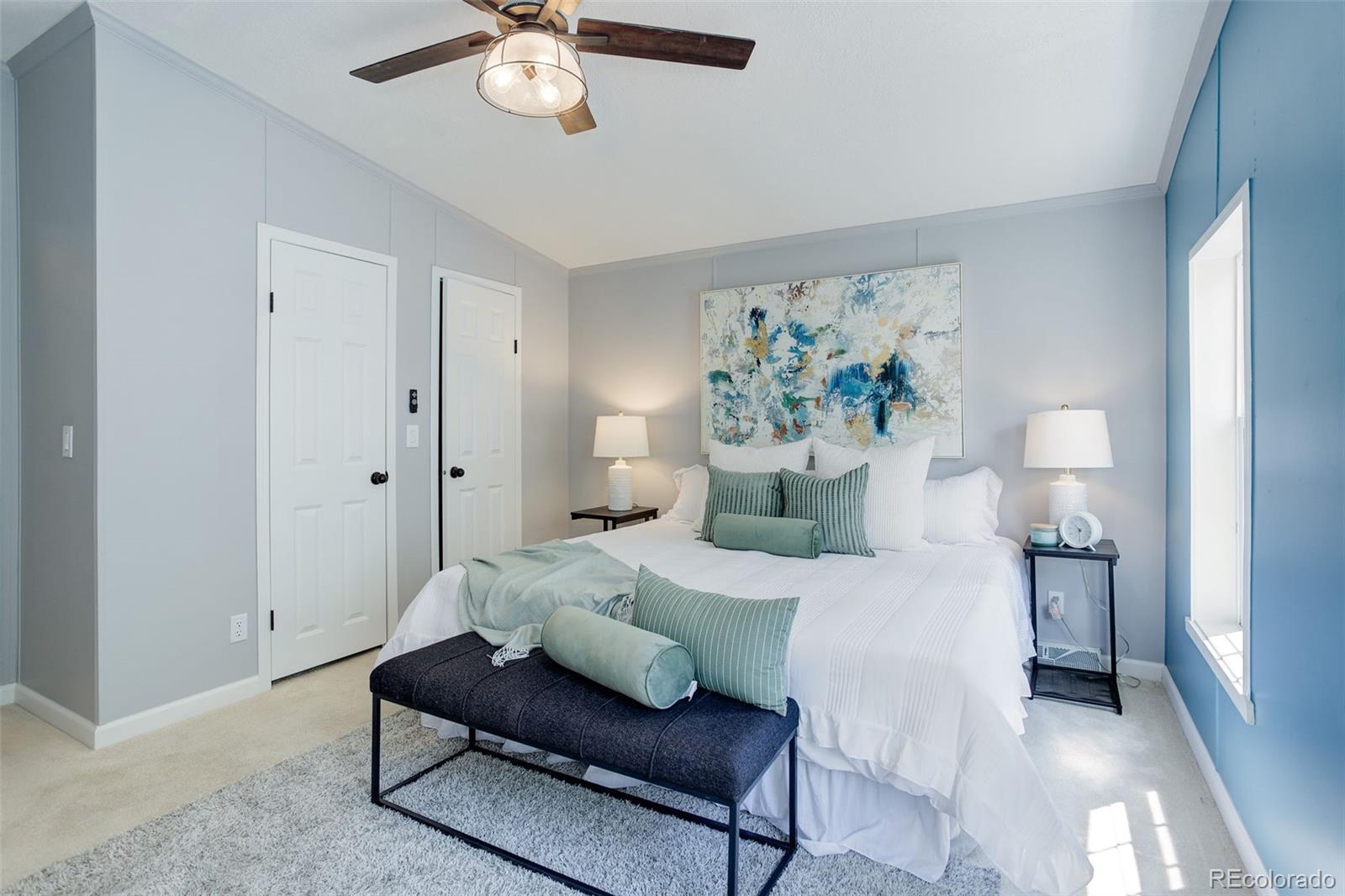5115 West Custer Place Denver, CO 80219 - Photo 12 of 25 a bedroom with a bed and a chandelier