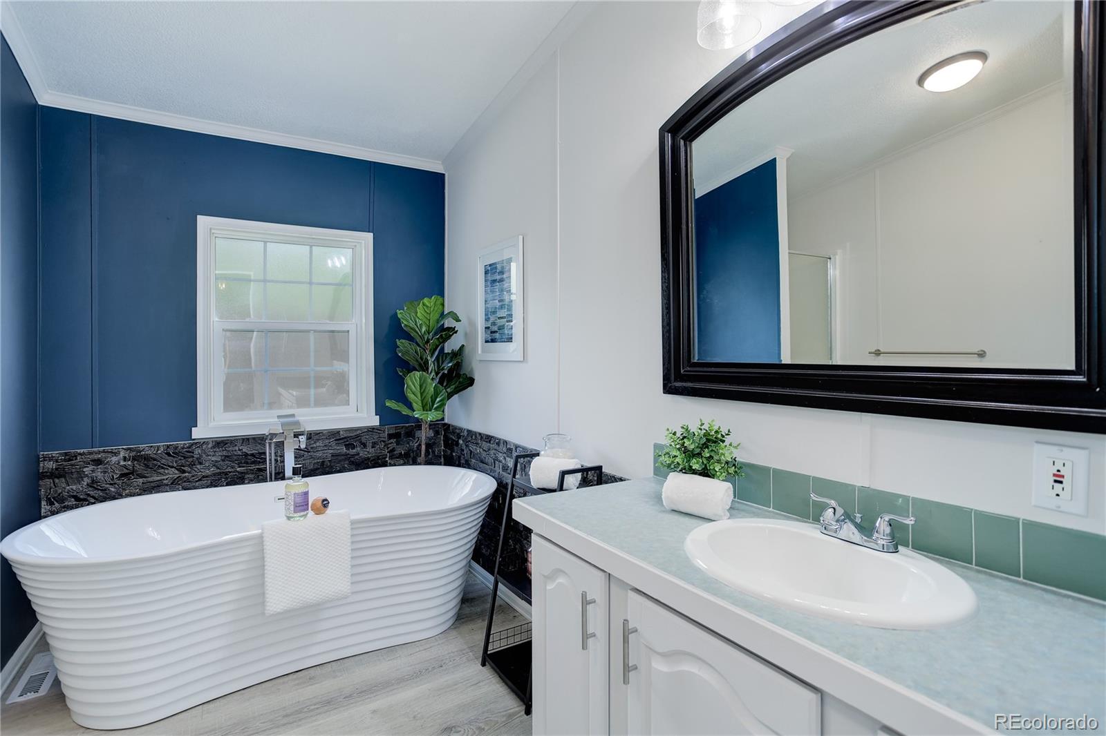 5115 West Custer Place Denver, CO 80219 - Photo 16 of 25 a bathroom with a bathtub and a sink