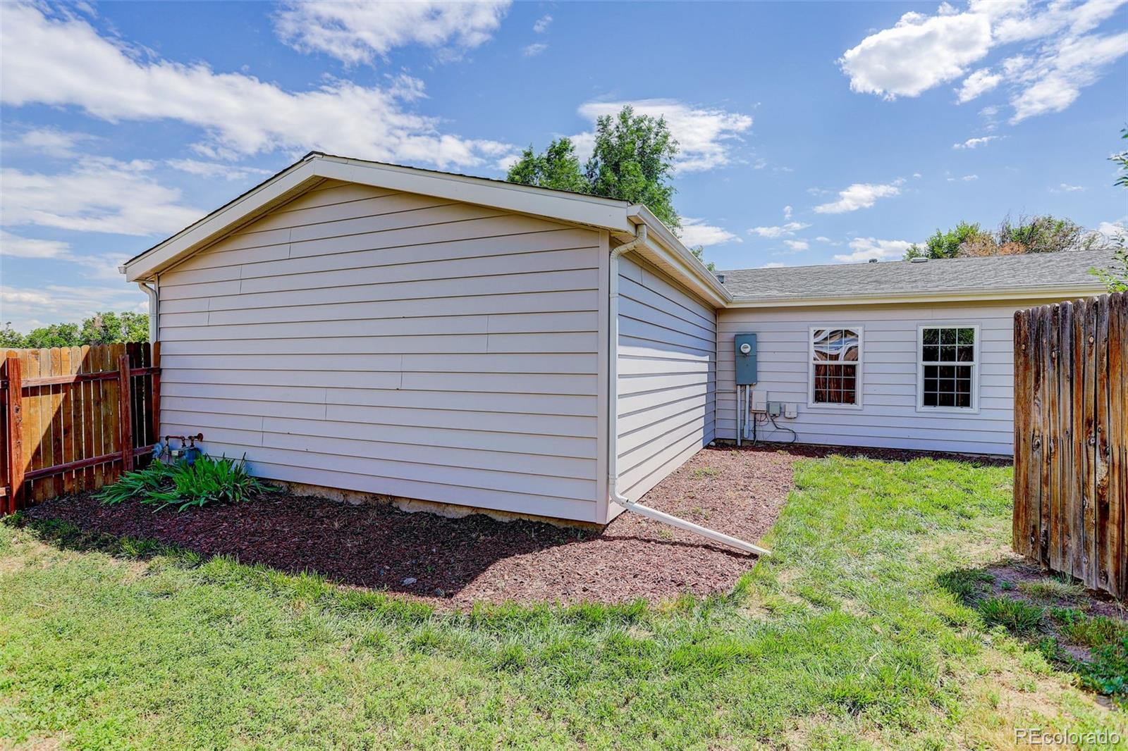 5115 West Custer Place Denver, CO 80219 - Photo 23 of 25 a front view of a house with garden