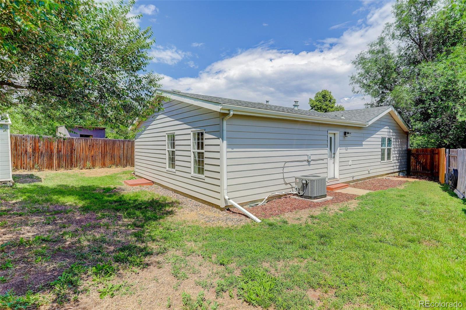 5115 West Custer Place Denver, CO 80219 - Photo 24 of 25 a backyard of a house with table and chairs