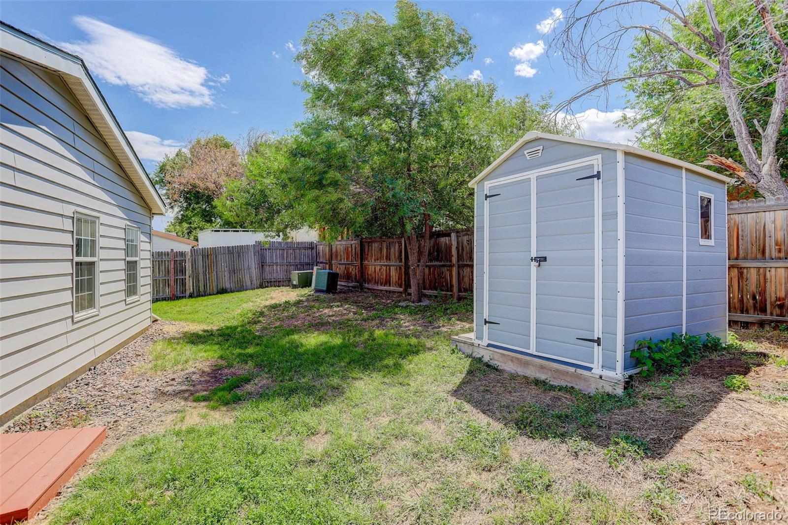 5115 West Custer Place Denver, CO 80219 - Photo 25 of 25 a backyard of a house with plants and tree