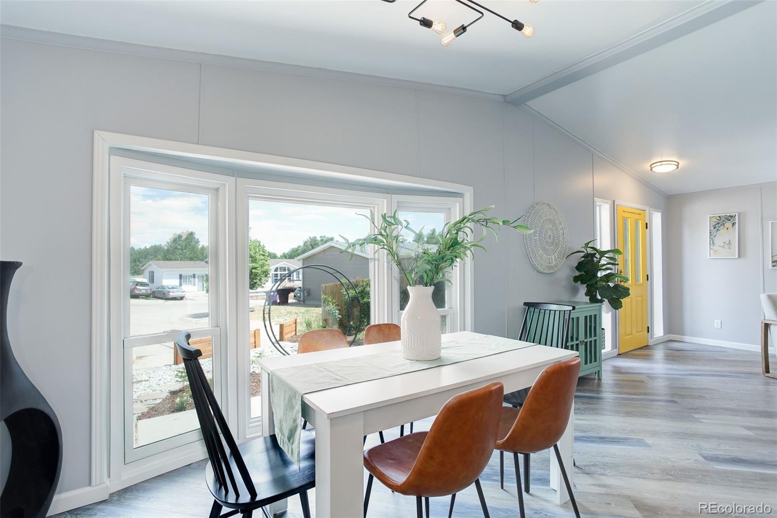 5115 West Custer Place Denver, CO 80219 - Photo 4 of 25 a view of a dining room with furniture window and wooden floor