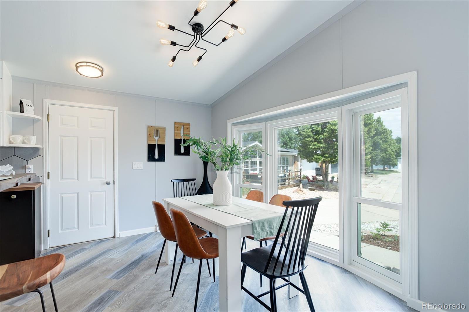 5115 West Custer Place Denver, CO 80219 - Photo 5 of 25 a view of a dining room with furniture window and wooden floor